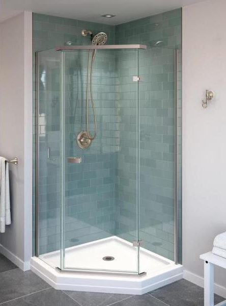 Modern shower enclosure with glass walls and tiled backsplash in a bathroom setting.