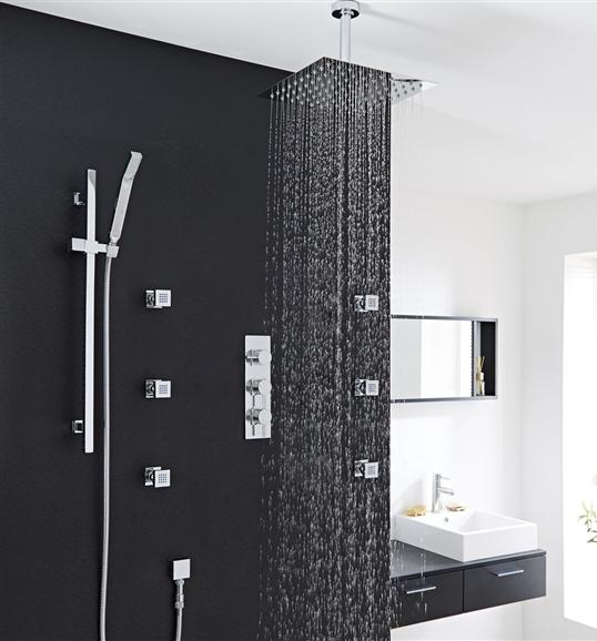 Modern shower setup with rainfall shower head and control panel on a black wall.